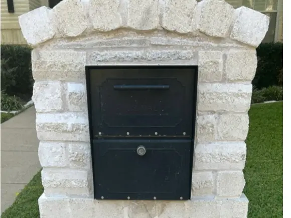 Brick mailbox after cleaning, bright white stone restored