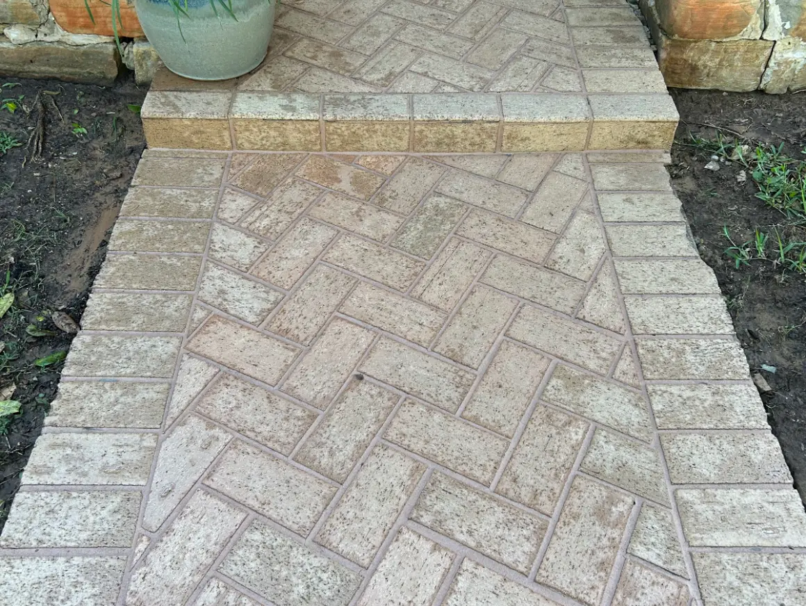 Clean herringbone paver walkway after pressure washing in the DFW area